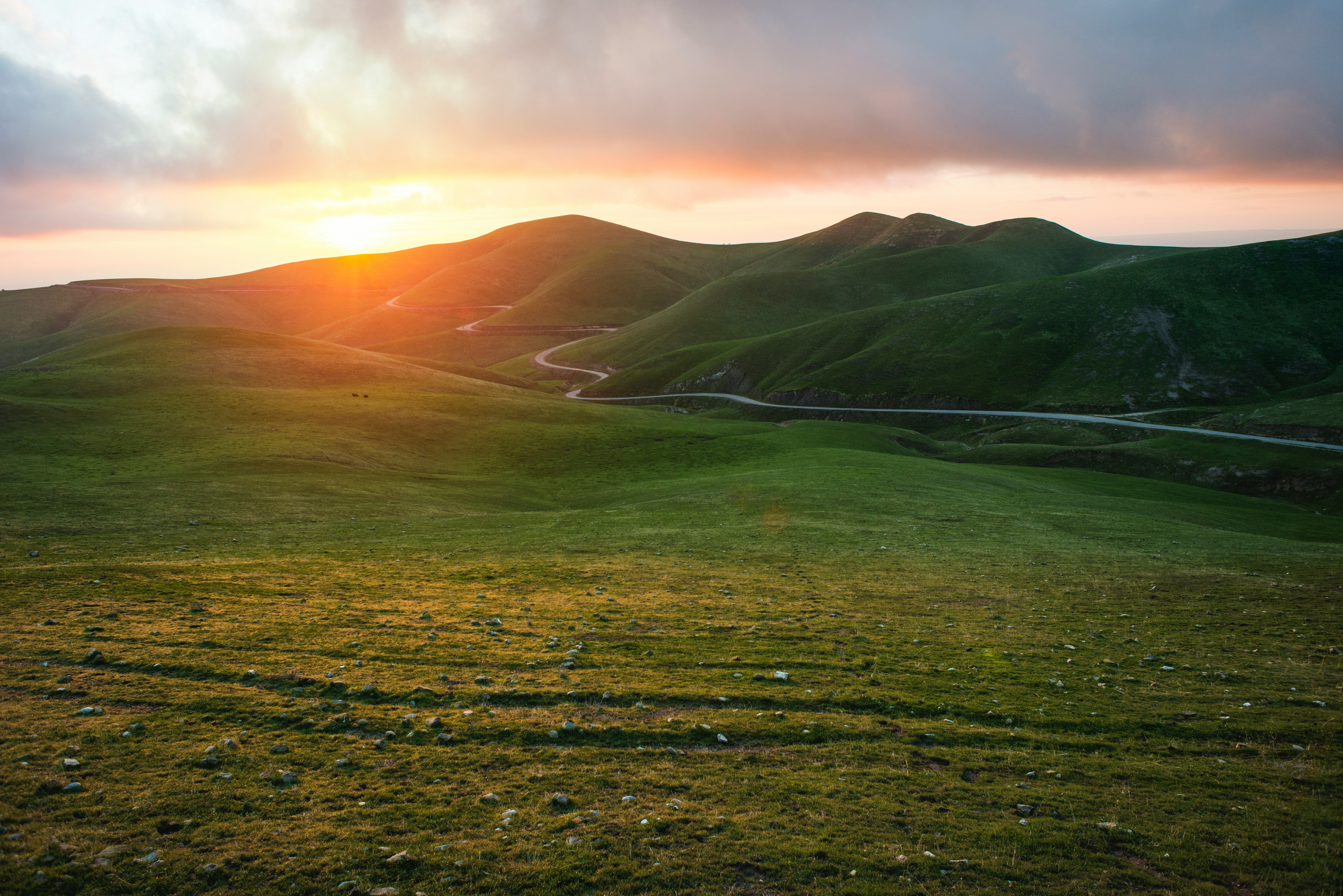 green mountain during sunset